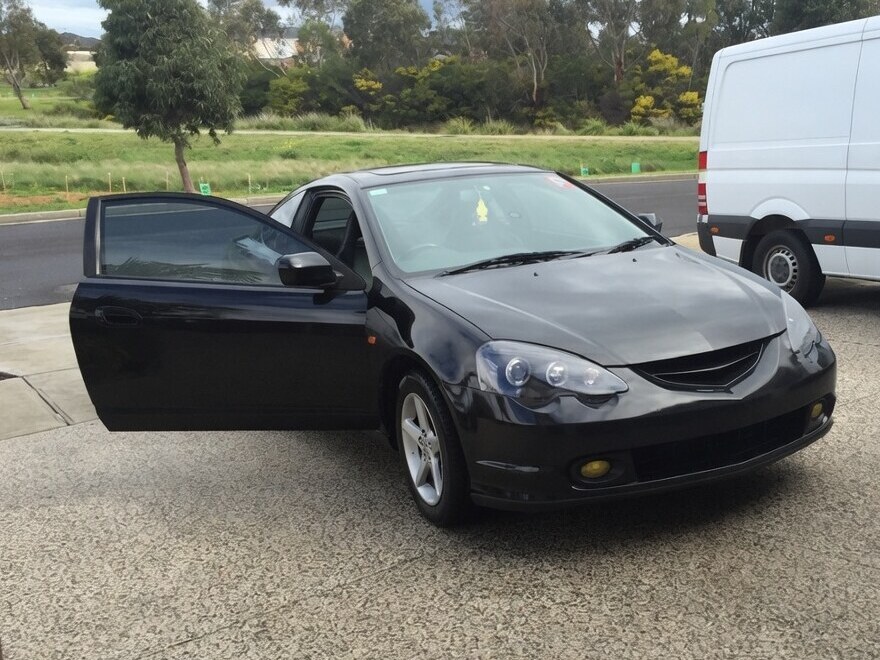 The black DC5 with the driver's door open